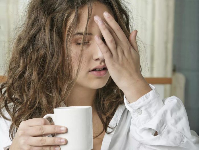 Woman with hangover and coffee