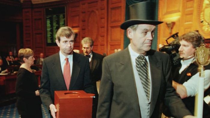 Massachusetts Secretary of the Commonwealth William Galvin, in the center, carries a ballot box containing the 12 Massachusetts electoral votes for Vice President Al Gore, as he is escorted by Sergeant-at-Arms Michael Rea, right, during the Electoral College voting at the Statehouse on December 18, 2000, in Boston.