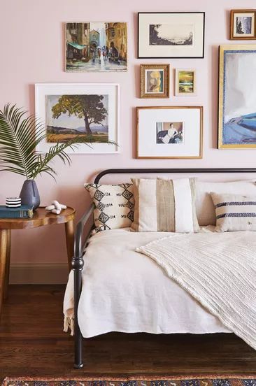 A bedroom with blush tones, gold accents, and brown details
