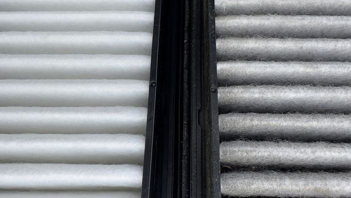 A clean air filter on the left versus a filter covered in dust and hair on the right.