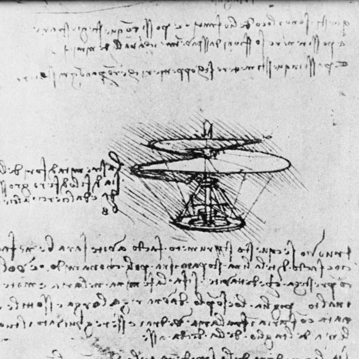 A page from a notebook by Leonardo da Vinci showing backwards handwriting and a diagram of a flying machine