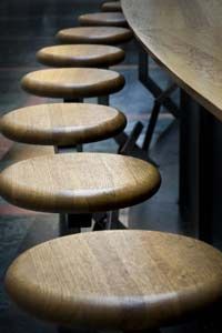 Bar stools placed around a bar area.