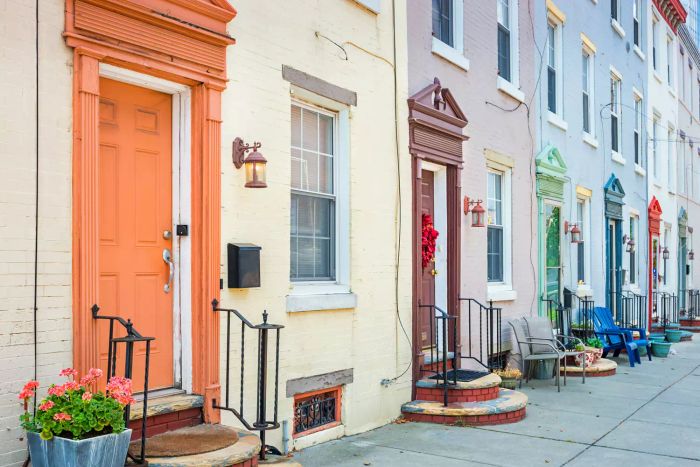 Stock image of a series of townhouses with vibrant front doors in downtown Philadelphia, Pennsylvania, USA.