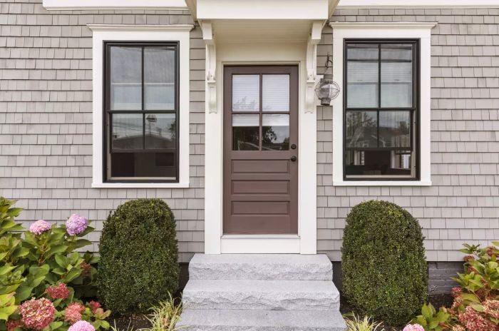 Front view of a classic home with two windows reflecting the image