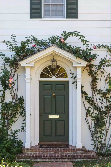 Green front door framed with ivy, creating an inviting appearance