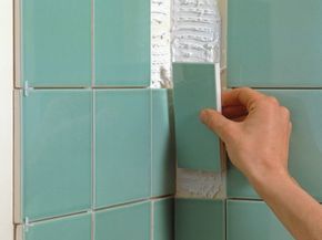 A man installing ceramic tile