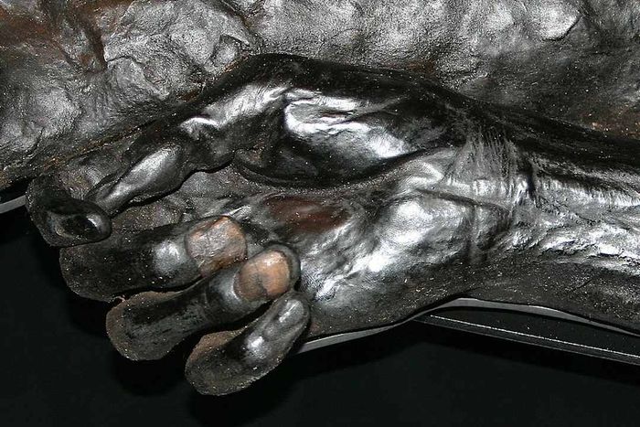 The hand and body of a figure known as Grauballe Man