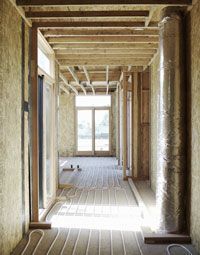 A partially built home showcasing the different components involved in a radiant heating system installation.