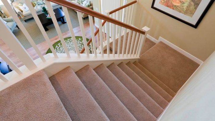 A view of carpeted stairs inside a contemporary American home.