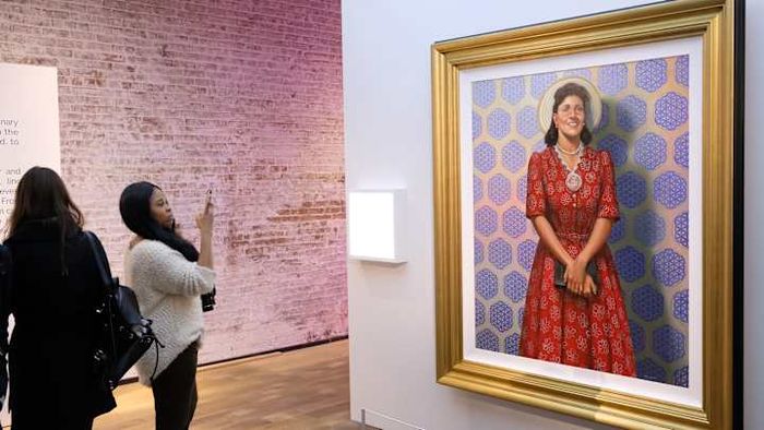 Visitors admire a portrait of Henrietta Lacks.