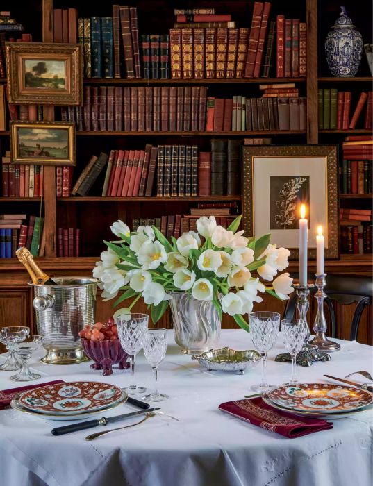 Parisian tablescape with fresh flowers on a table in a library room