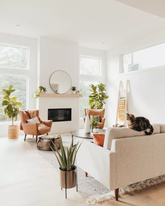 White living room featuring large windows and a fireplace