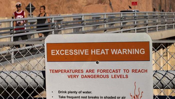 A warning posted at the Hoover Dam highlights the dangerously high temperatures on September 16, 2022, in Boulder City, Nevada.