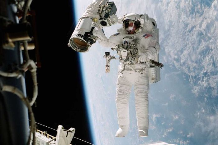 Astronaut William (Bill McArthur) Appears Suspended Over The Blue And White Earth October