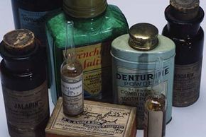 A variety of bottles filled with old, common household chemicals.