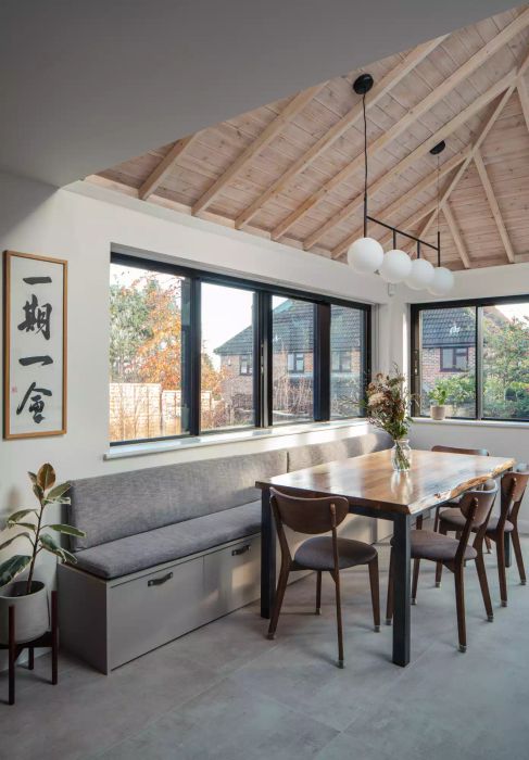 dining nook with tall ceilings and large windows