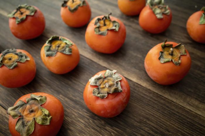 Several persimmons arranged on a table