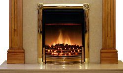 A classic pine fire surround featuring an electric fire on a marble hearth.