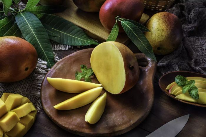 A mango sliced into wedges and halves