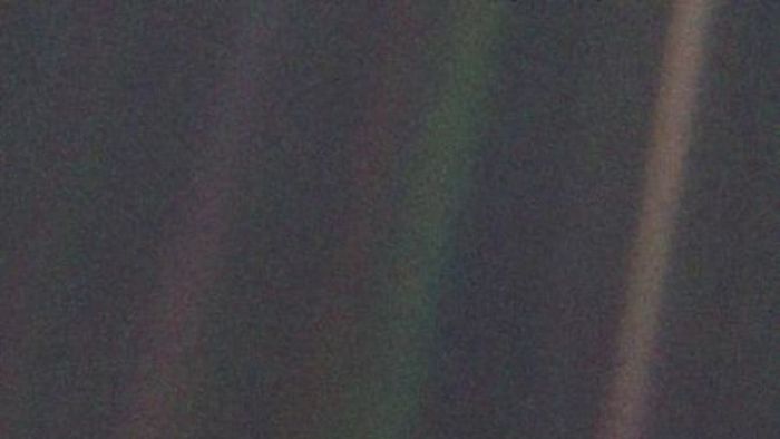 The photograph of Earth taken by Voyager 1 from a distance of 4 billion miles, which became known as 'The Pale Blue Dot.'