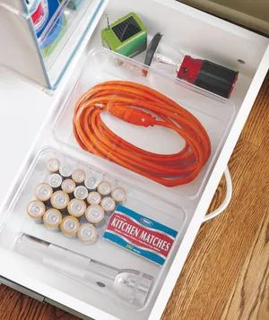 Tidy Drawer Container with Batteries, Matches, and an Orange Cord