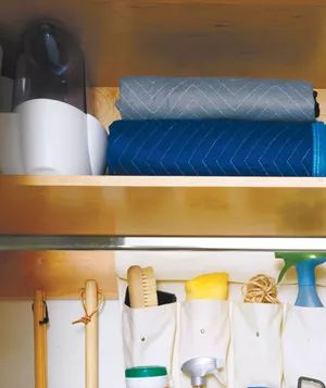 Humidifier and blankets stored on the high shelves of the utility closet