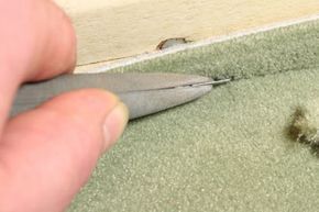A close-up image showcasing the process of carpet installation.