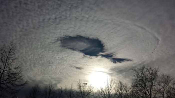 A fallstreak hole with a menacing aura over Naples, Italy.