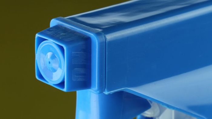 A blue spray bottle nozzle