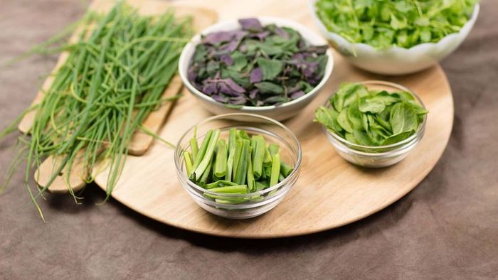 A rotating tray, often known as a Lazy Susan, bringing fresh green vegetables within easy reach.