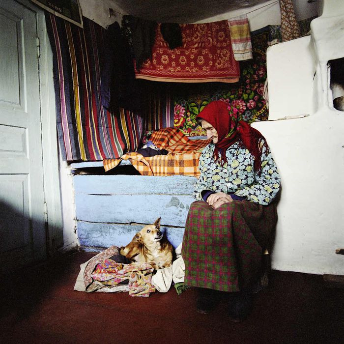 A woman in the Chernobyl Exclusion Zone converses with her dog.