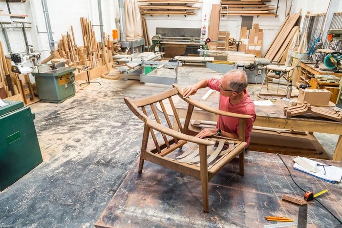 Woodworkers crafting furniture in a workshop setting