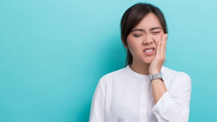 Her toothache is actually helping her prevent further harm to her teeth.