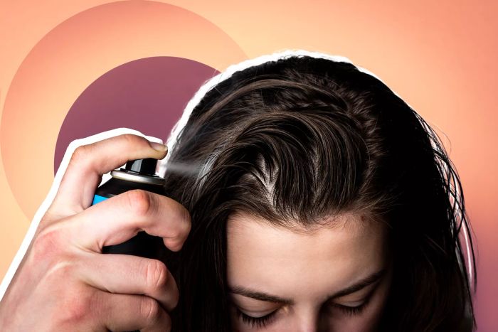 P&G Aerosol Dry Spray and Shampoo Recall, Woman applying dry spray shampoo to her dirty hair
