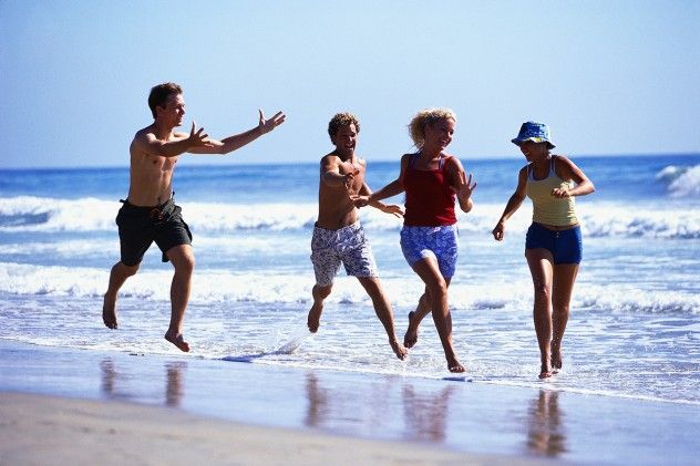Young Men Chasing Young Women on the Beach
