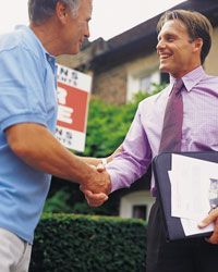 A person shaking hands with a real estate agent