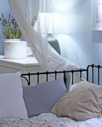 A bedroom with soft blue walls offers a peaceful and calming ambiance, ideal for a restful sleep environment.