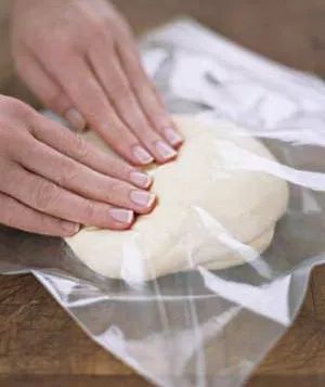 Woman kneading dough in a Ziploc bag
