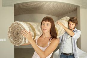 Couple carrying carpet