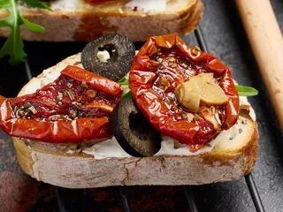 A sandwich with cream cheese and sun-dried tomatoes, a delightful snack