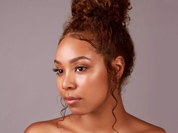 A woman with an updo and baby hairs