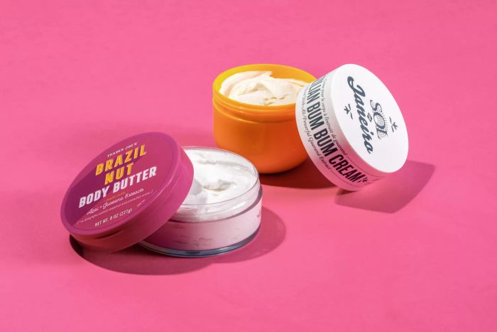 Trader Joe's Brazilian Bum Bum Cream and Body Butter displayed on a vibrant pink background