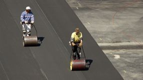 Workers are installing artificial turf at Clark University