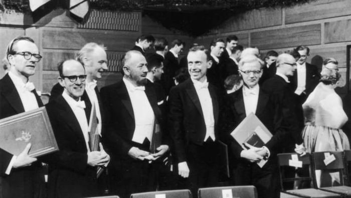 Maurice Wilkins (left), Francis Crick (third from left), and James Watson (fifth from left) receive their Nobel Prize in 1962.