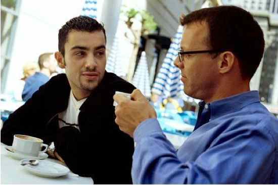 Two Friends Chatting in a Coffee Shop