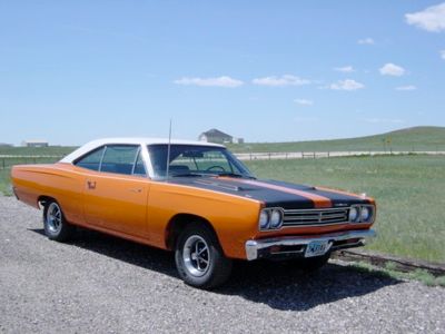 The 1969 Plymouth Roadrunner was an iconic muscle car that earned its place in automotive history. Named after the famous Warner Brothers cartoon character, it was a car that prioritized performance over luxury, much like its animated namesake. Under the hood, the Roadrunner boasted a 383-cubic-inch V8 engine that produced 335 horsepower, allowing it to race down the quarter-mile in the low 14-second range. Plymouth positioned the Roadrunner as a more affordable alternative to the pricier muscle cars of the time, and it quickly gained popularity for its performance at a reasonable price. A unique feature of the Roadrunner was the 'beep-beep' horn, inspired by the cartoon character. With its combination of speed, fun, and affordability, the Roadrunner became a beloved symbol of American muscle cars, and it continues to be a favorite among collectors and car enthusiasts.