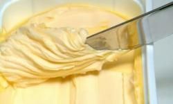 A butter knife smoothly slicing through soft butter.