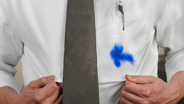 A white dress shirt with a blue ink stain from a pen in the pocket
