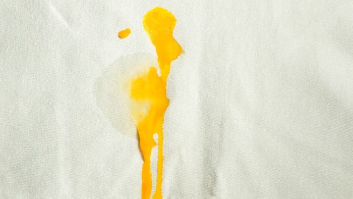 An egg yolk stain on a pristine white shirt can be tricky to deal with.