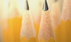 A close-up image showing two sharpened pencils